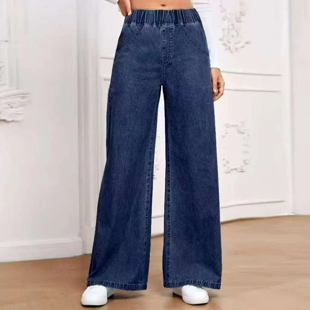 Plus size light blue washed denim trousers with a wide-leg straight cut and zip fly.