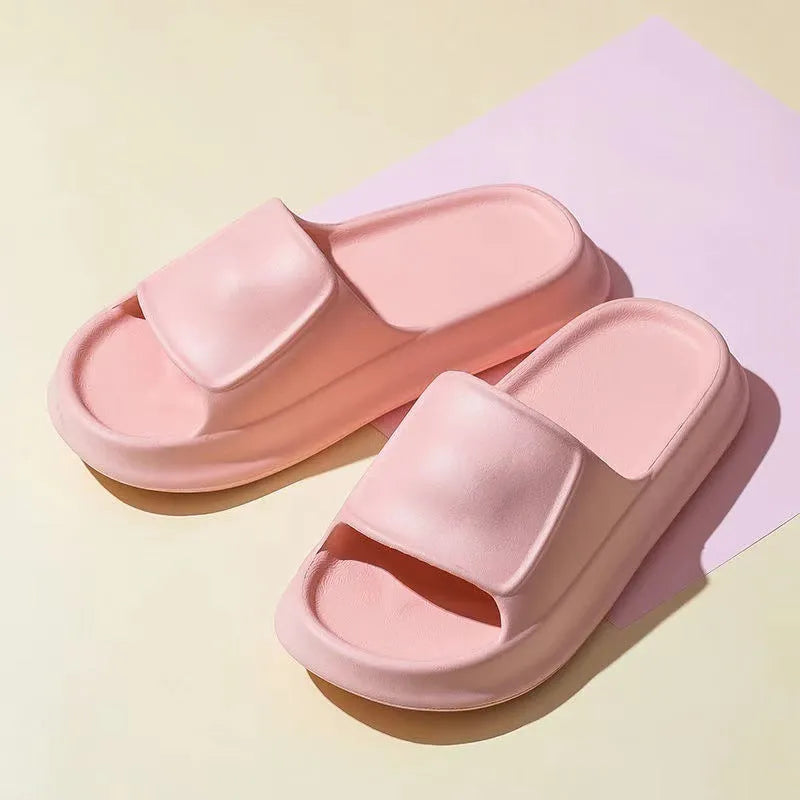 Pair of thick-soled white EVA flip-flop slippers with a non-slip patterned sole.