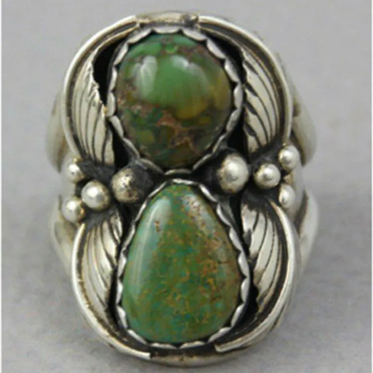 A geometric turquoise ring with a silver-toned alloy band and a retro design.