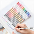 Muji 12-pack of clear barrel gel pens with 0.5mm fine nibs and visible ink, arranged neatly.