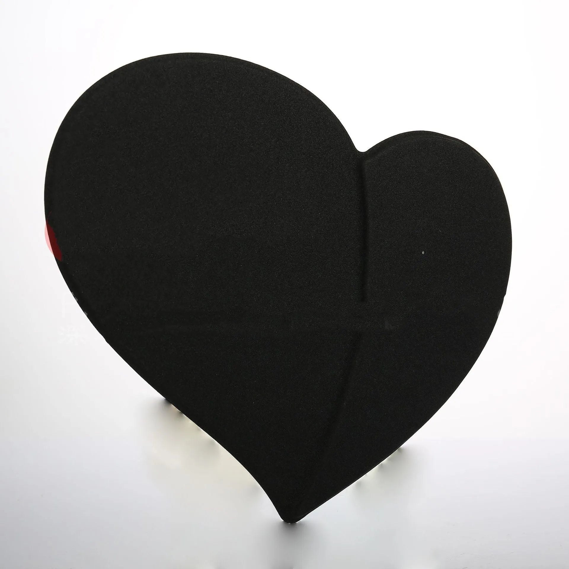 Heart shaped red leather wireless charging mouse pad with indicator light on a desk
