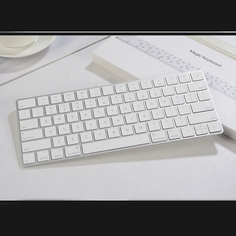 White Apple G6 Bluetooth wireless keyboard with ultra-thin metal design on desk