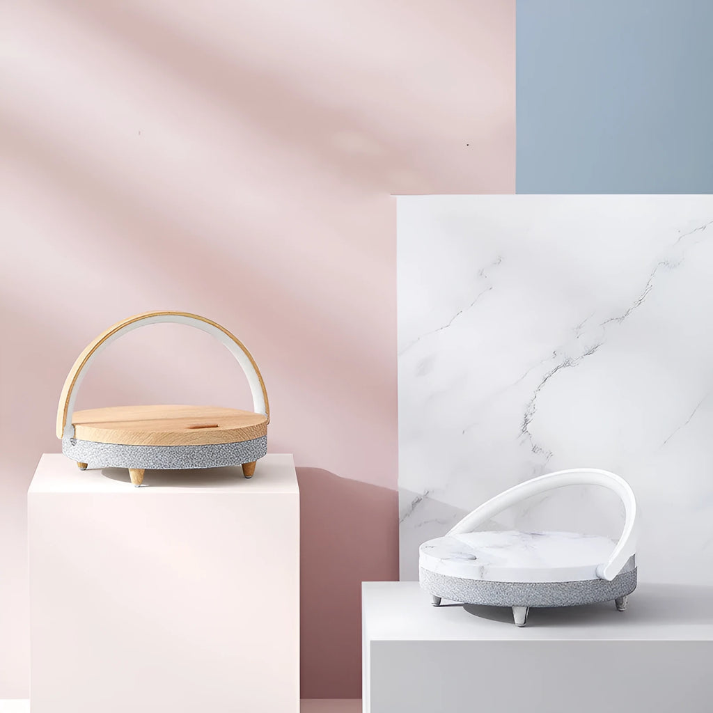 Wireless charging night light with Bluetooth speaker showing marble pattern finish and mobile phone resting in integrated holder