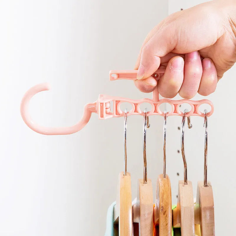 Blue revolving wardrobe hanger with five rotating branches and a top handle.