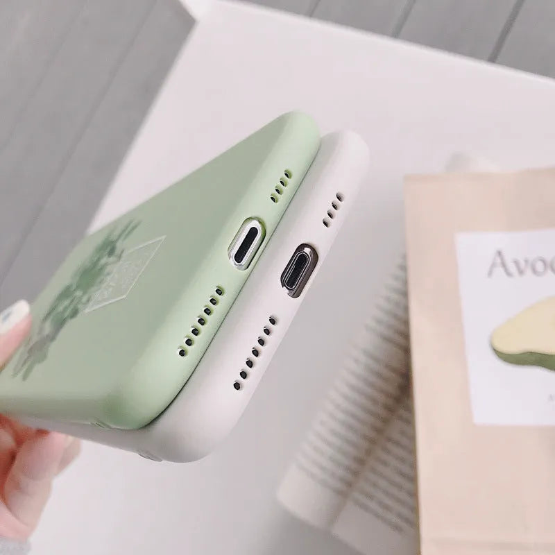 White silicone iPhone case with a detailed painted plant pattern on the back.