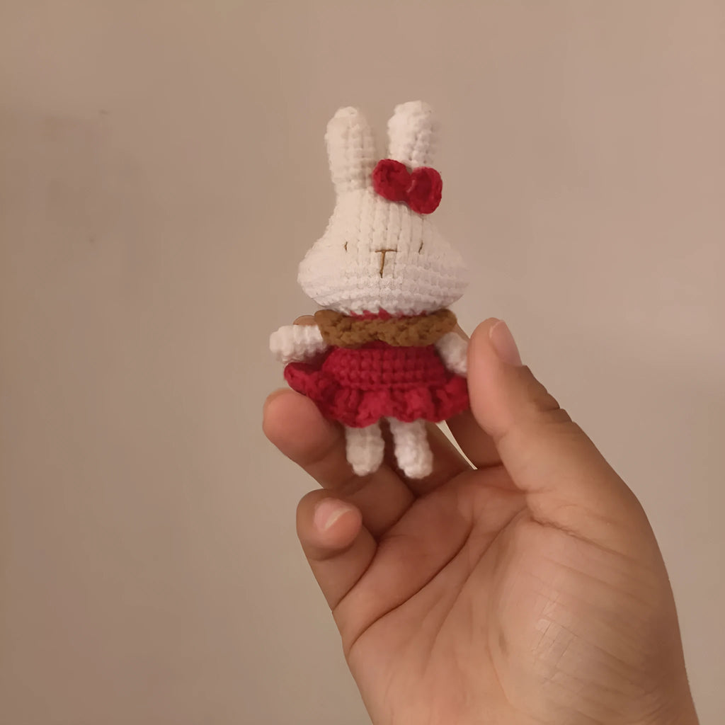 Hand-crocheted wool rabbit key chain with cute design, shown in two style options