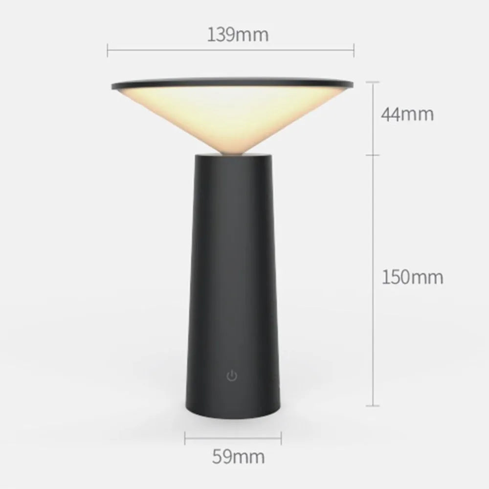 Black USB rechargeable desk lamp with touch sensor base and a tilted lamp head on a wooden desk.