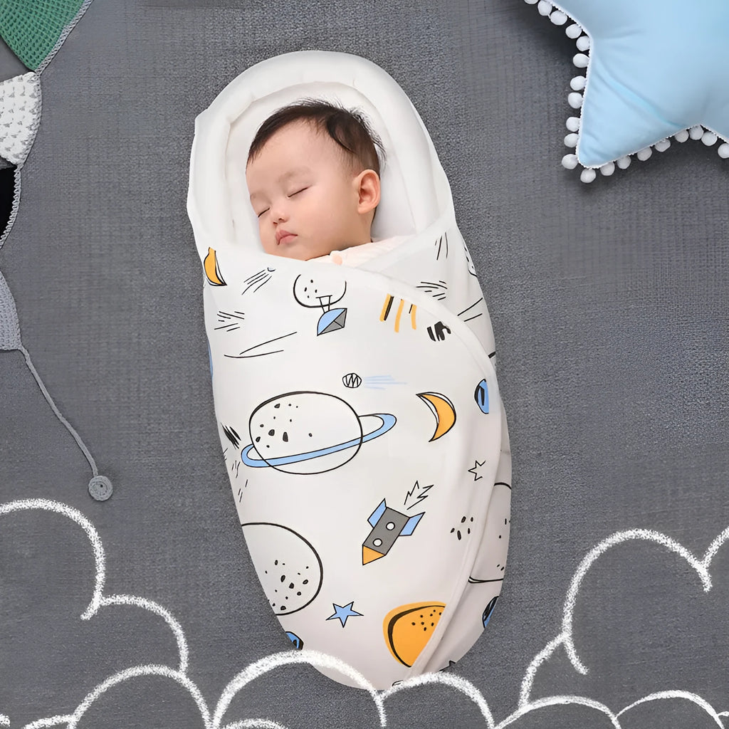 Cotton baby anti startle swaddle measuring 30 by 60 centimetres in a colourful print design.