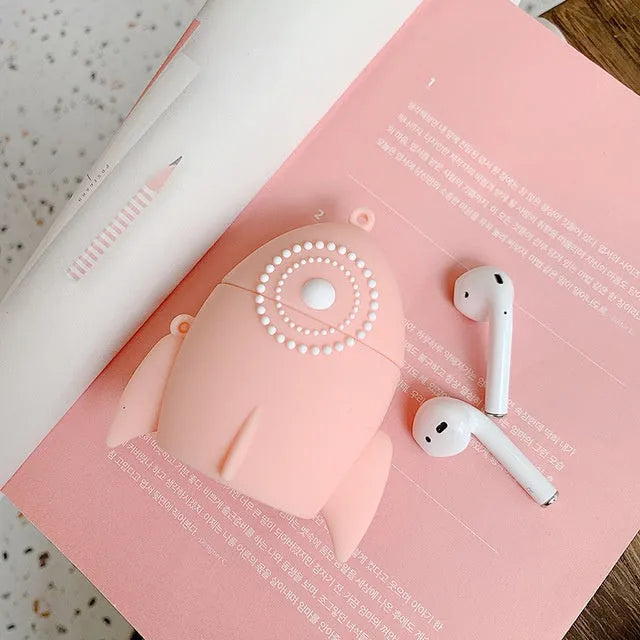 Pink silicone AirPods case with raised rocket design next to black plain version