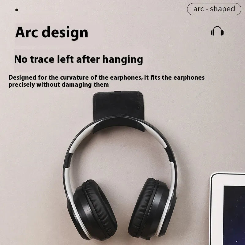 Black plastic headphone bracket mounted on wall with universal fit for headset storage