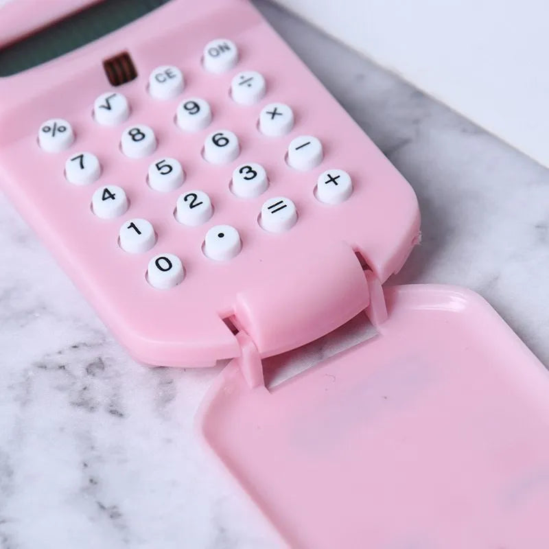 Creative cookie-shaped cute mini calculator in pink with key ring on a white background