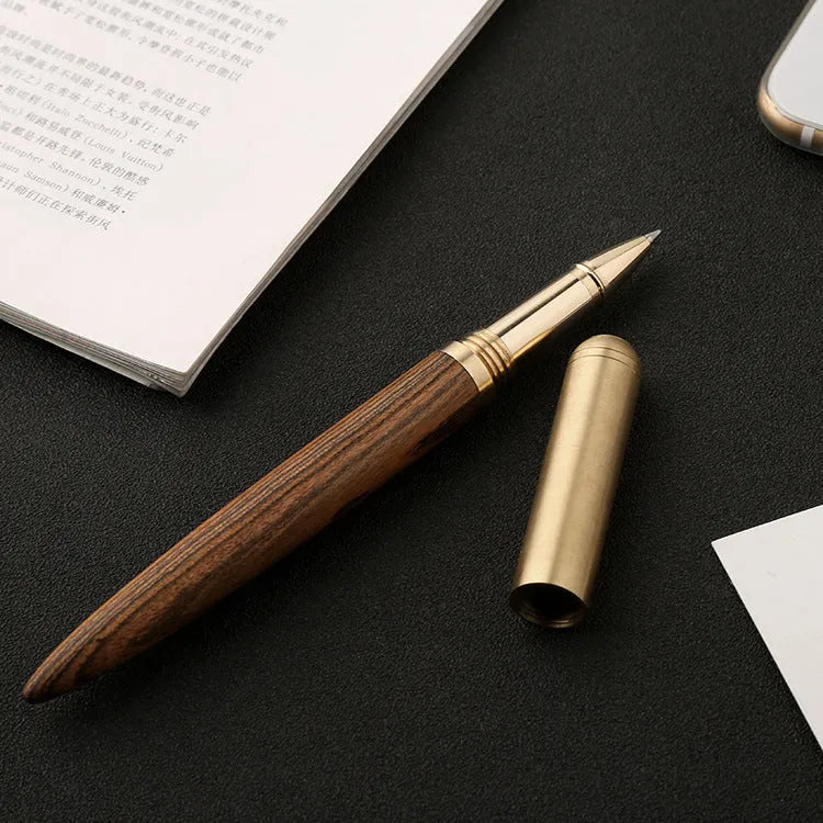 Brass and solid wood signature pen showing wood grain and metallic details.