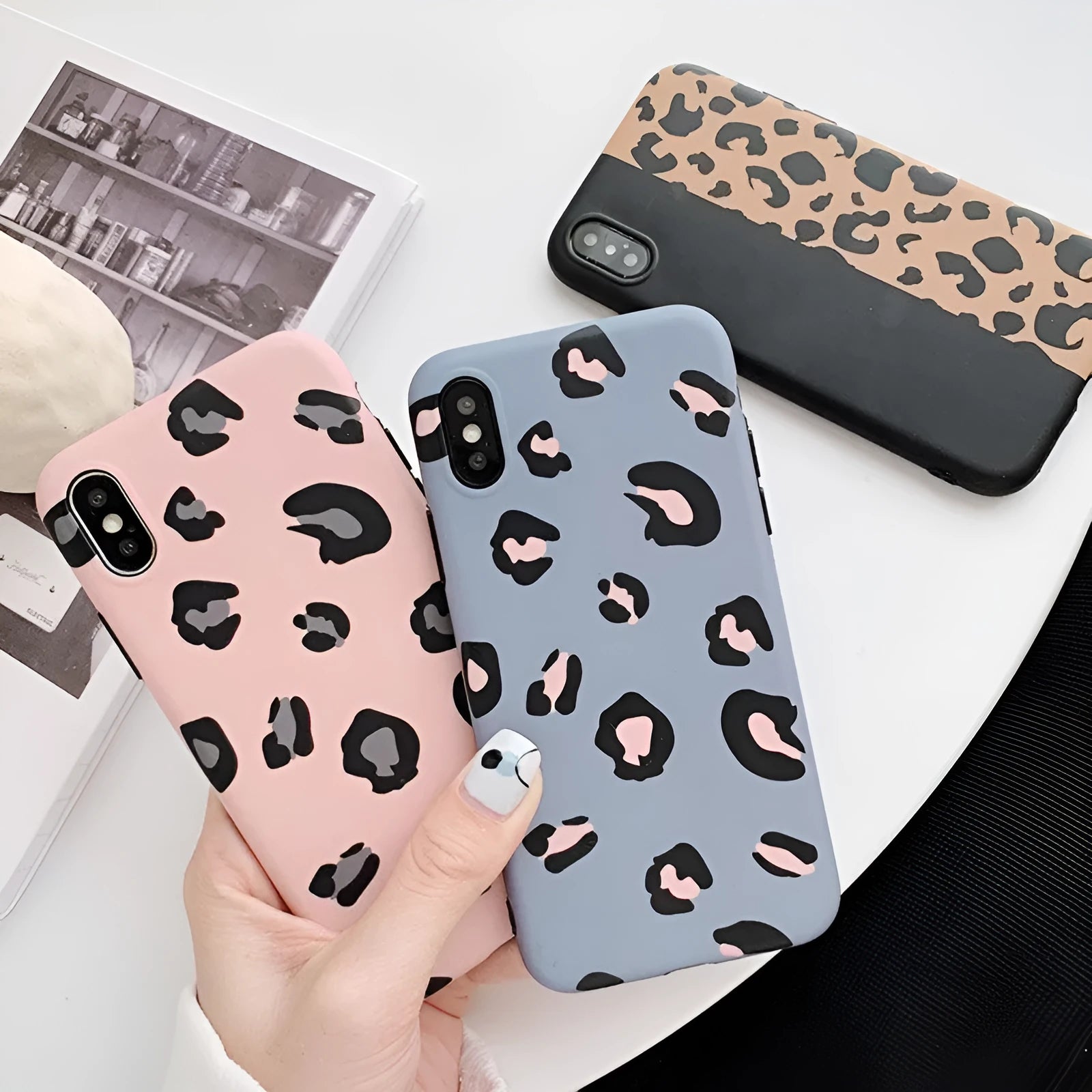 Leopard print pattern protective back cover case for iPhone, shown in black, blue, and pink colour options.