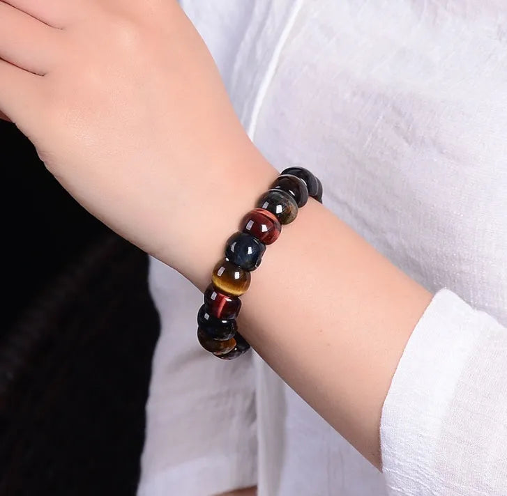 Natural tiger eye stone bracelet with round 14x10mm beads in red colour on a neutral background