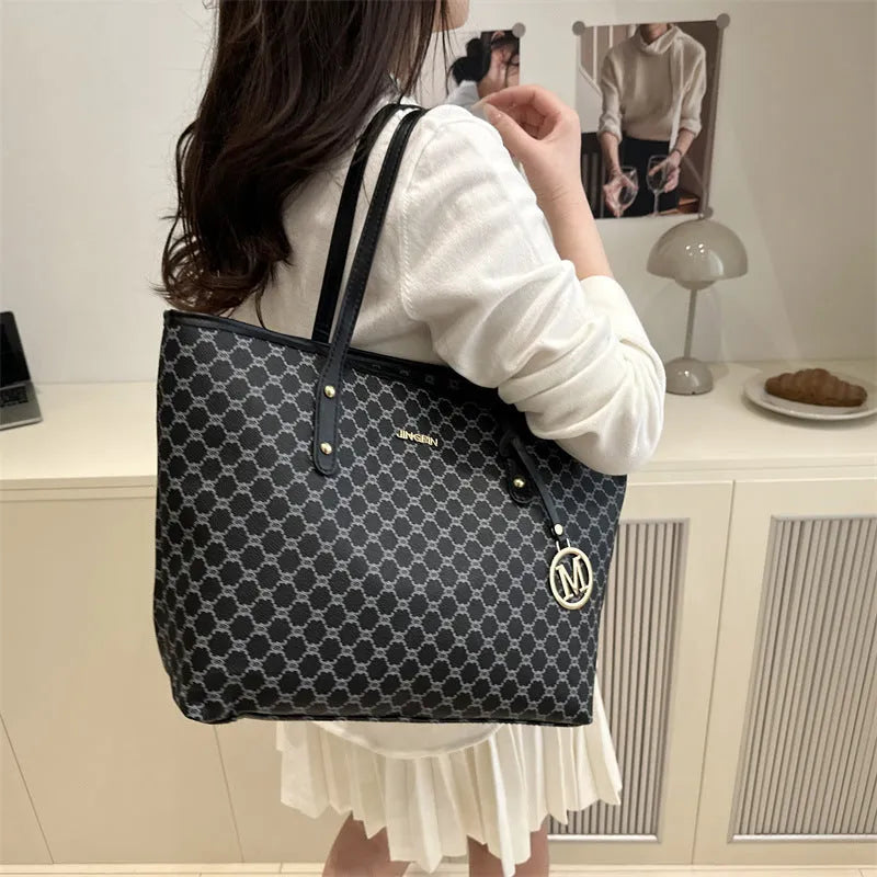 PU leather shoulder bag with adjustable strap in black, shown with visible stitching detail.