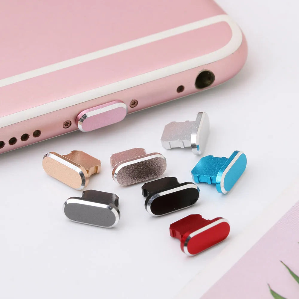 Aluminium alloy iPhone charging port dust plug in various colours on a white background.