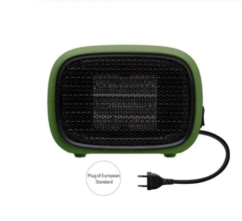 Green mini portable heater with dimensions 158mm x 90mm x 114mm on a wooden desk.