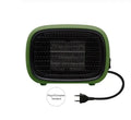 Green mini portable heater with dimensions 158mm x 90mm x 114mm on a wooden desk.