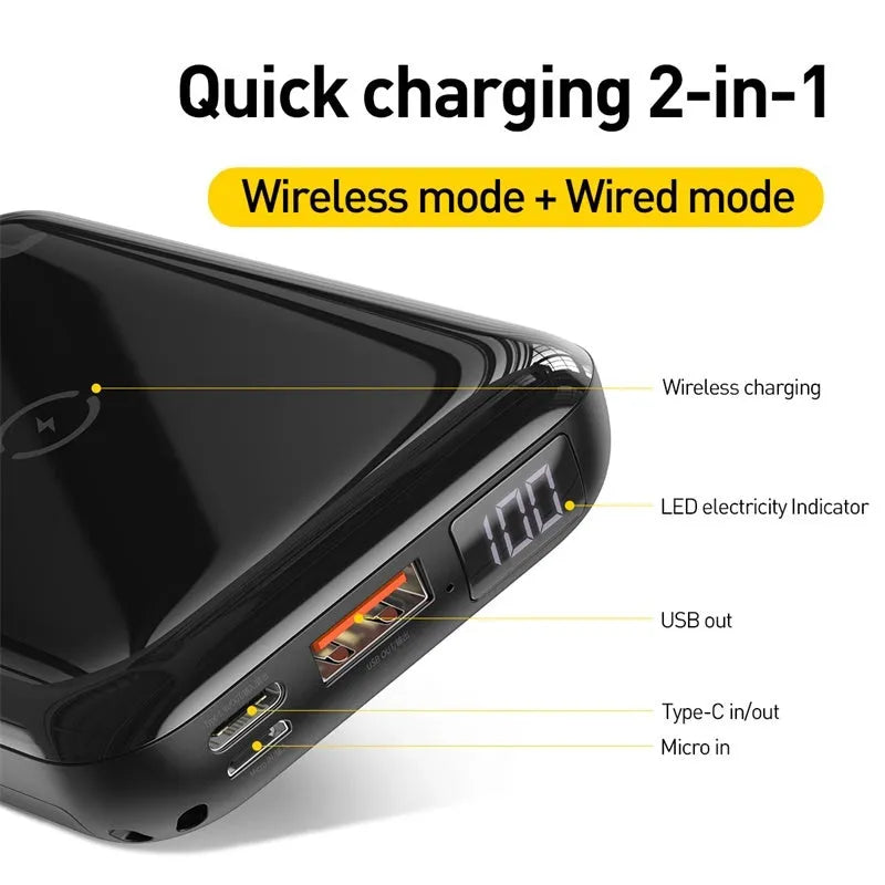 Square black wireless power bank with digital display showing battery percentage, next to a smartphone on its wireless charging surface.