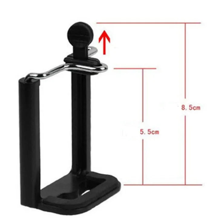 Mini aluminium tripod extended with ball head, shown alongside a U-shaped smartphone clip on a table.