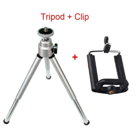 Mini aluminium tripod extended with ball head, shown alongside a U-shaped smartphone clip on a table.
