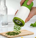White plastic herb grinder mill with stainless steel blades and ergonomic handle for chopping fresh herbs