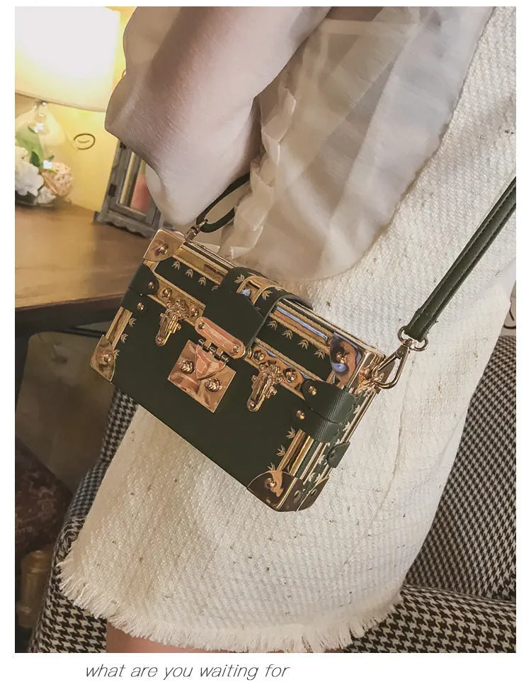 Women's black or green hard flap top shoulder bag made of PU leather with rivet details.