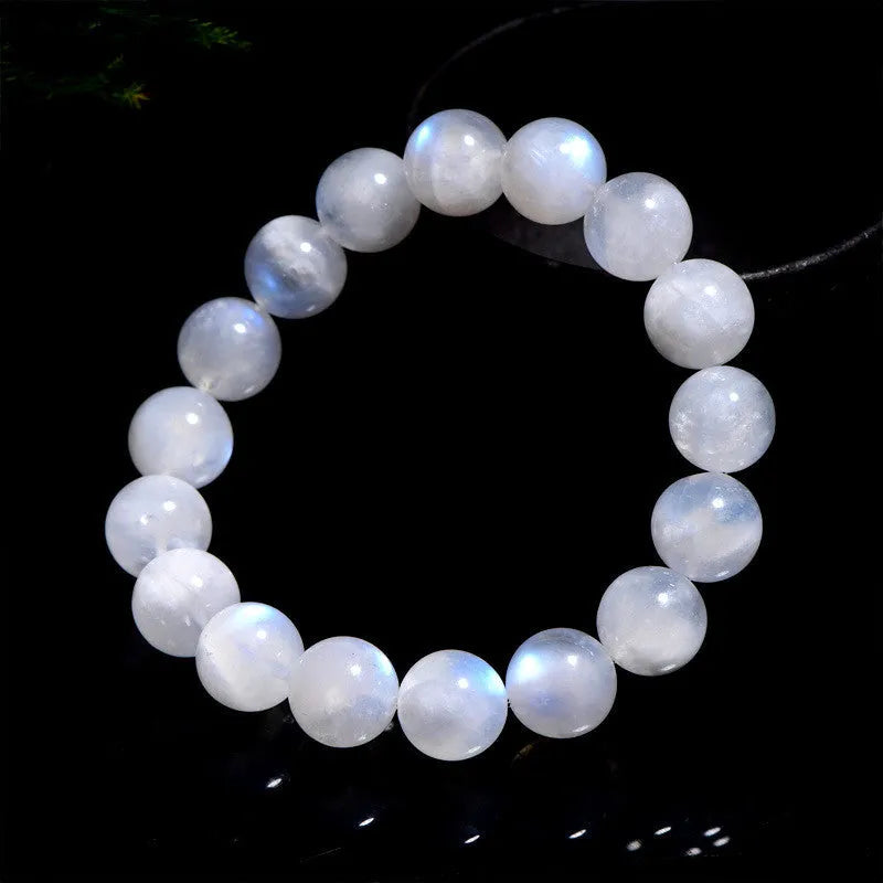 Natural blue moonlight round bead moonstone bracelet on a white background, showing polished geometric beads.