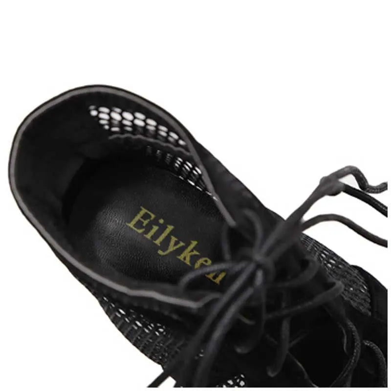 Black suede women's lace-up high heel shoes with an 11.5cm heel on a plain background