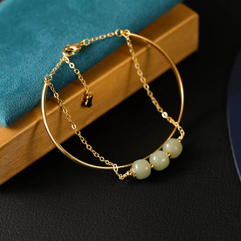 Women's Hetian jade lucky beads bracelet with gold inlay in a fake two pieces style.