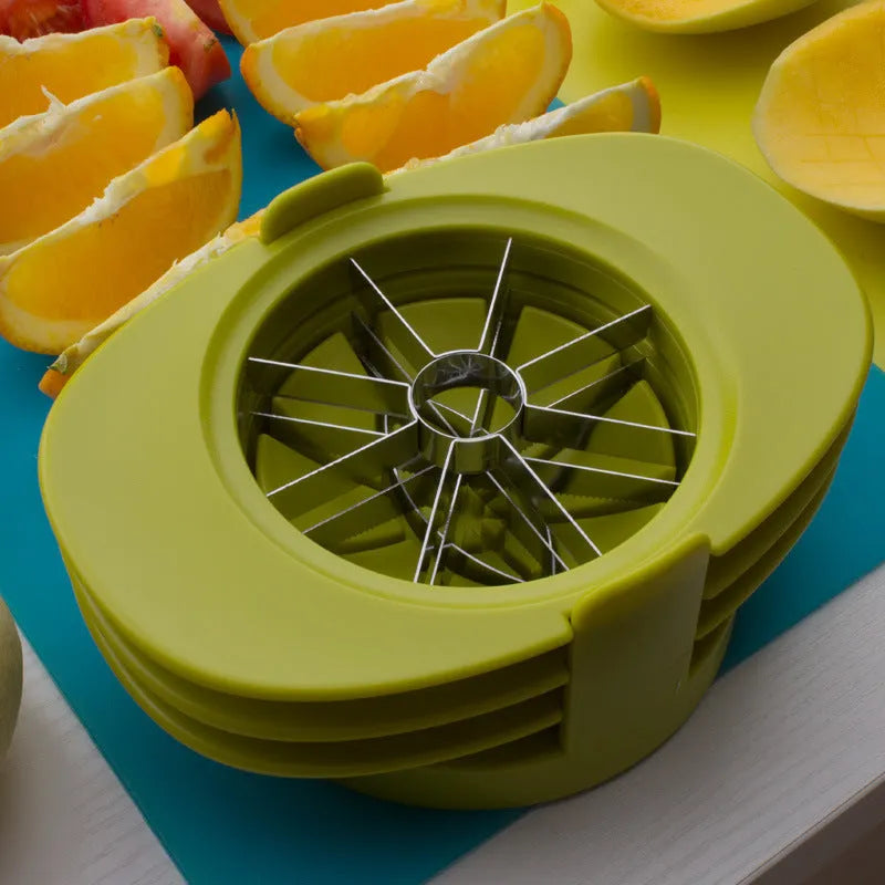 Green plastic fruit slicer for apple, tomato and mango cuts with base on a kitchen counter