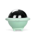 Green UFO-shaped plastic night light projecting a starry sky pattern onto a surface.