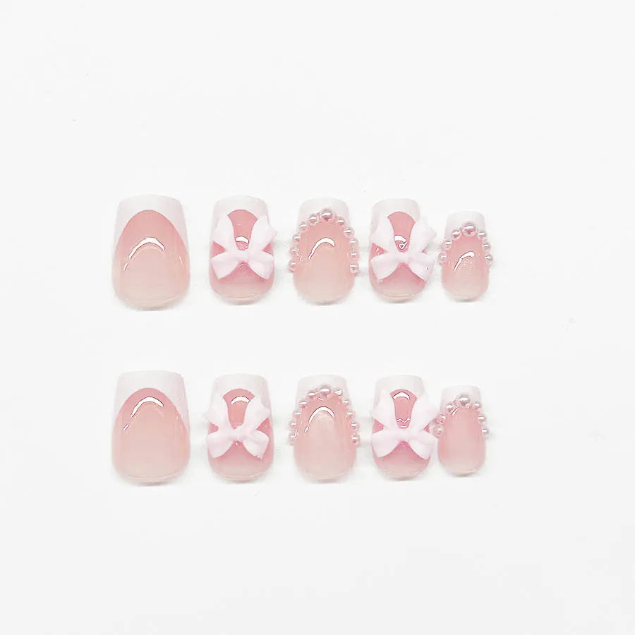 Set of 24 short, square false nails with pre-designed bow, tulip, starry sky, and leopard print patterns for a French manicure.