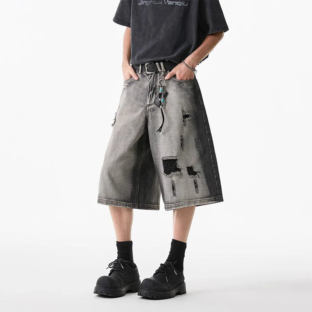 Grey women's denim shorts with water washed finish and hole distressing, loose cropped fit