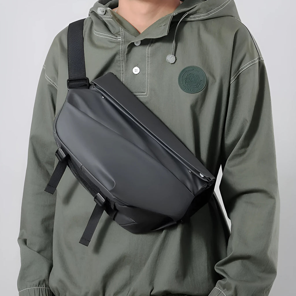 Grey men's PU leather crossbody bag showing front zipper and adjustable strap.