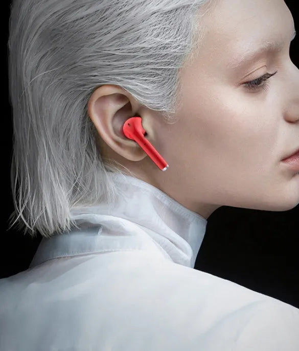 Fashion lipstick case open to show black Bluetooth earbuds with in-ear design.