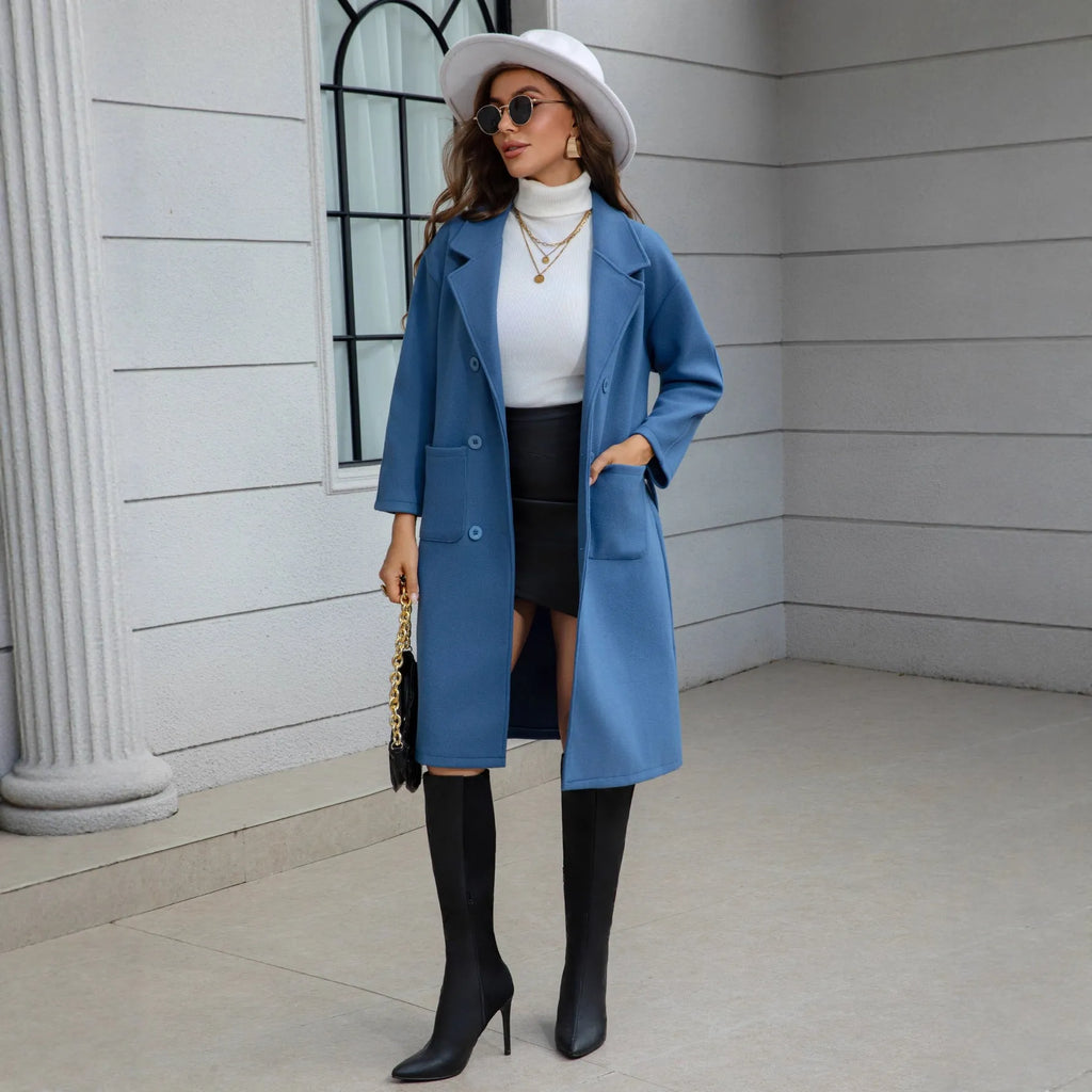 Blue waist-tie mid-length women's wool coat with long sleeves, pockets, and patchwork details