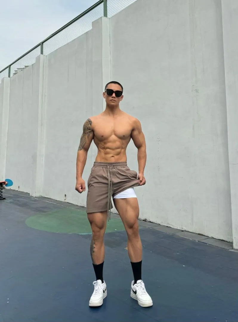 Men's ice silk quick-drying shorts in light grey, showing double-layer quarter-length leg design.