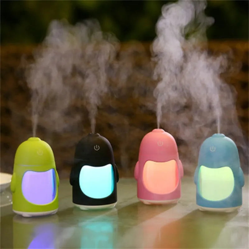Penguin humidifier with soft blue nightlight glow, 150ml cool mist diffuser, USB powered, available in pink