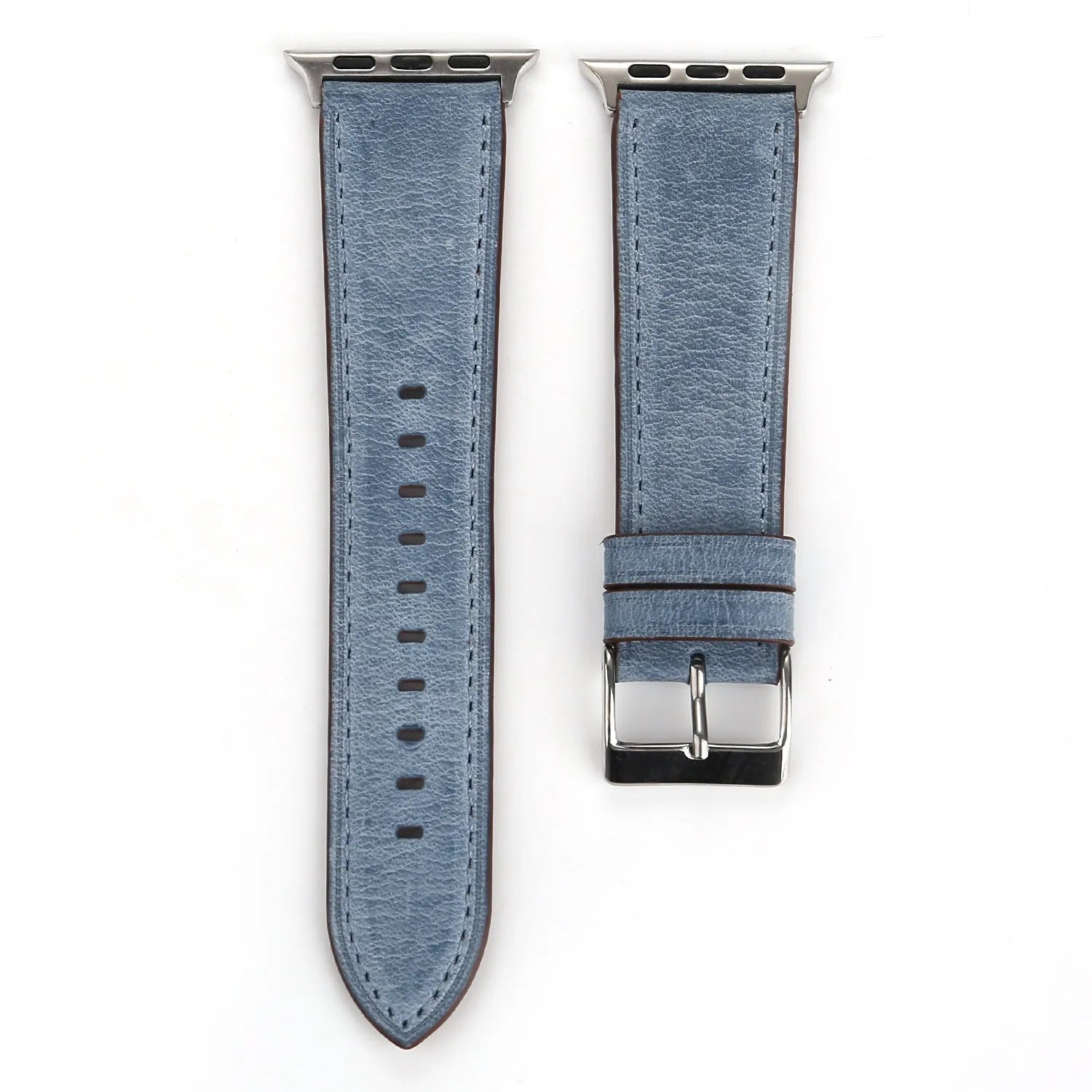 Leather watch strap with a metal folding buckle on a wooden surface.