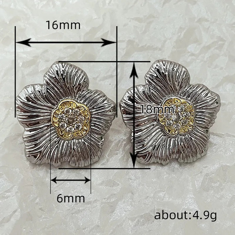 Retro copper stud earrings with a textured gardenia design in a two-tone electroplated finish.