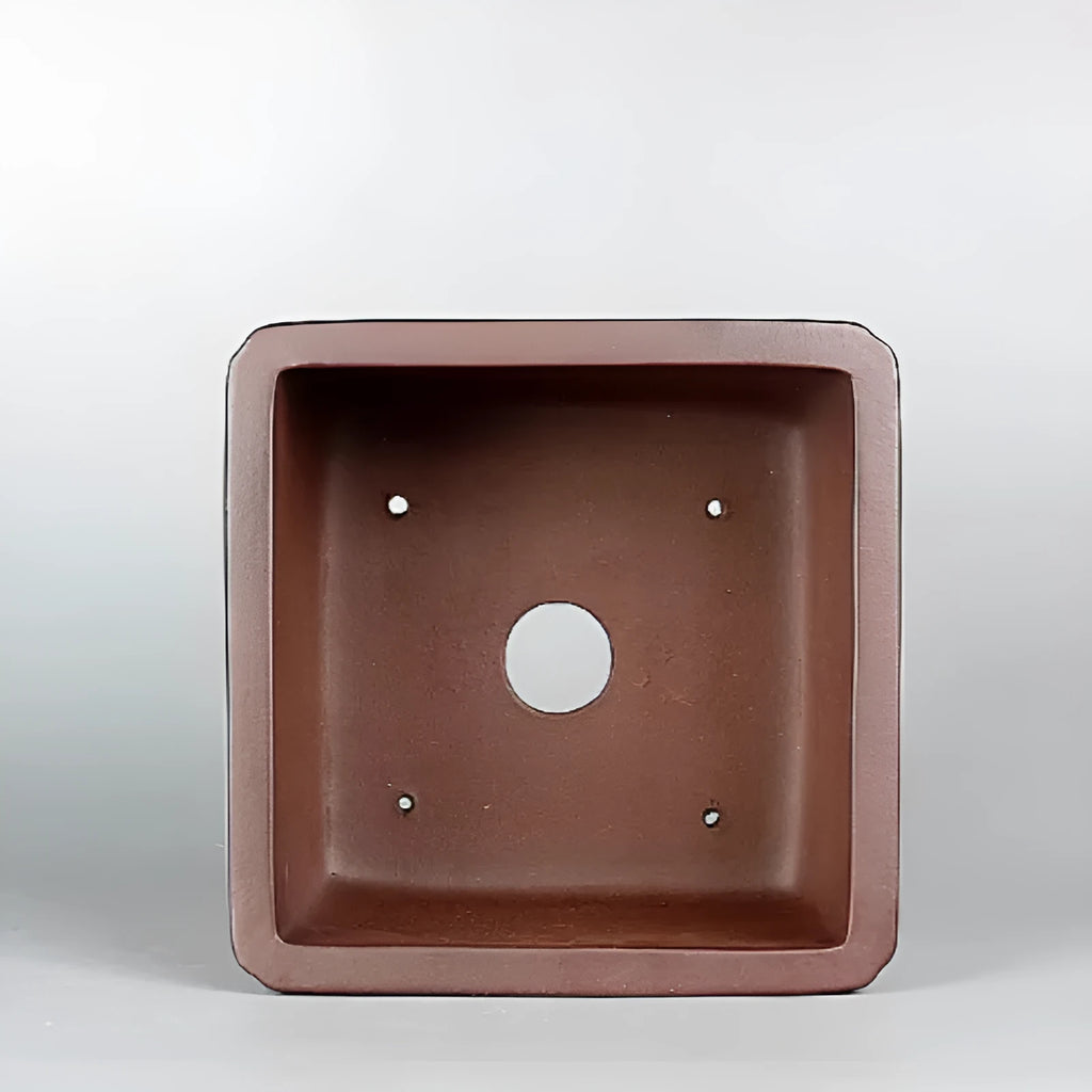 Brown handmade antique purple clay flower pot for indoor plants.