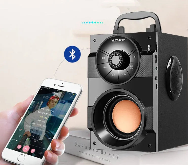 Black portable mini home audio system with subwoofer, cable, and USB power connection.