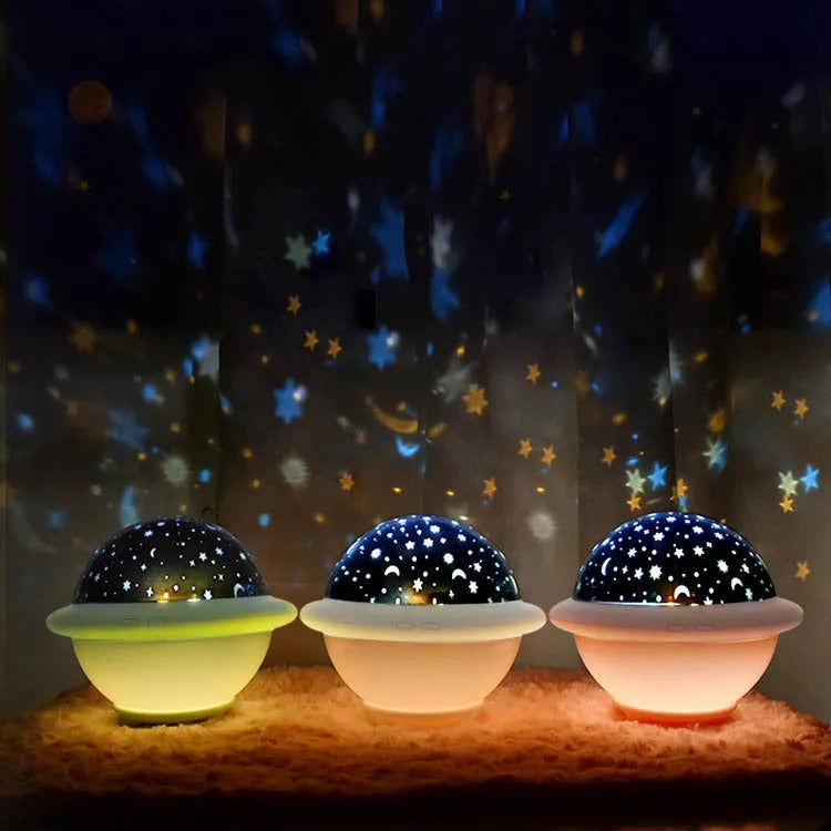 Green UFO-shaped plastic night light projecting a starry sky pattern onto a surface.