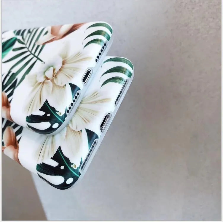 LOVECOM floral iPhone back case with banana leaf design on a smartphone.