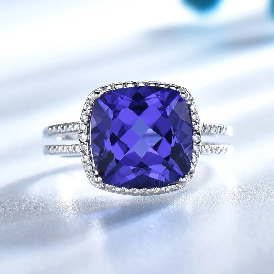 Women's sterling silver ring with a blue tanzanite gemstone on a silver band.