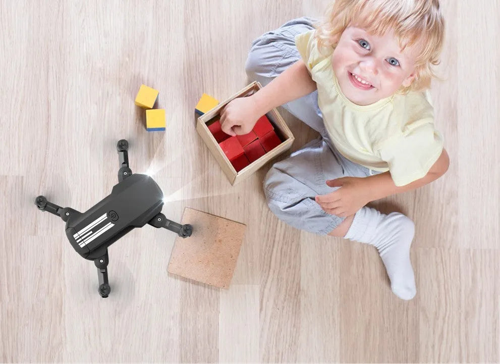 LS Mini foldable drone with 4K camera in black and grey, unfolded on a flat surface