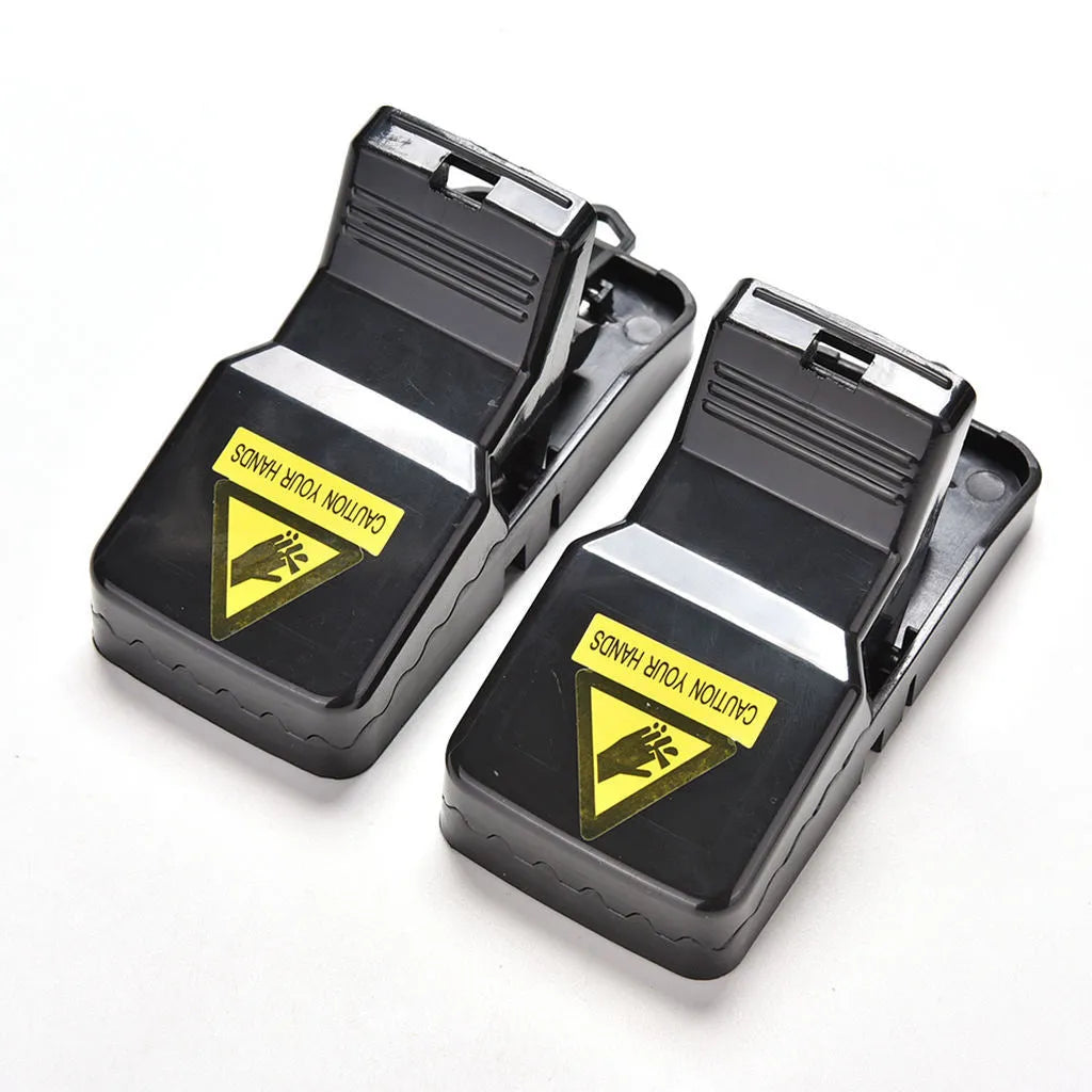 Six black plastic snapping mousetraps showing compact size and smooth surface