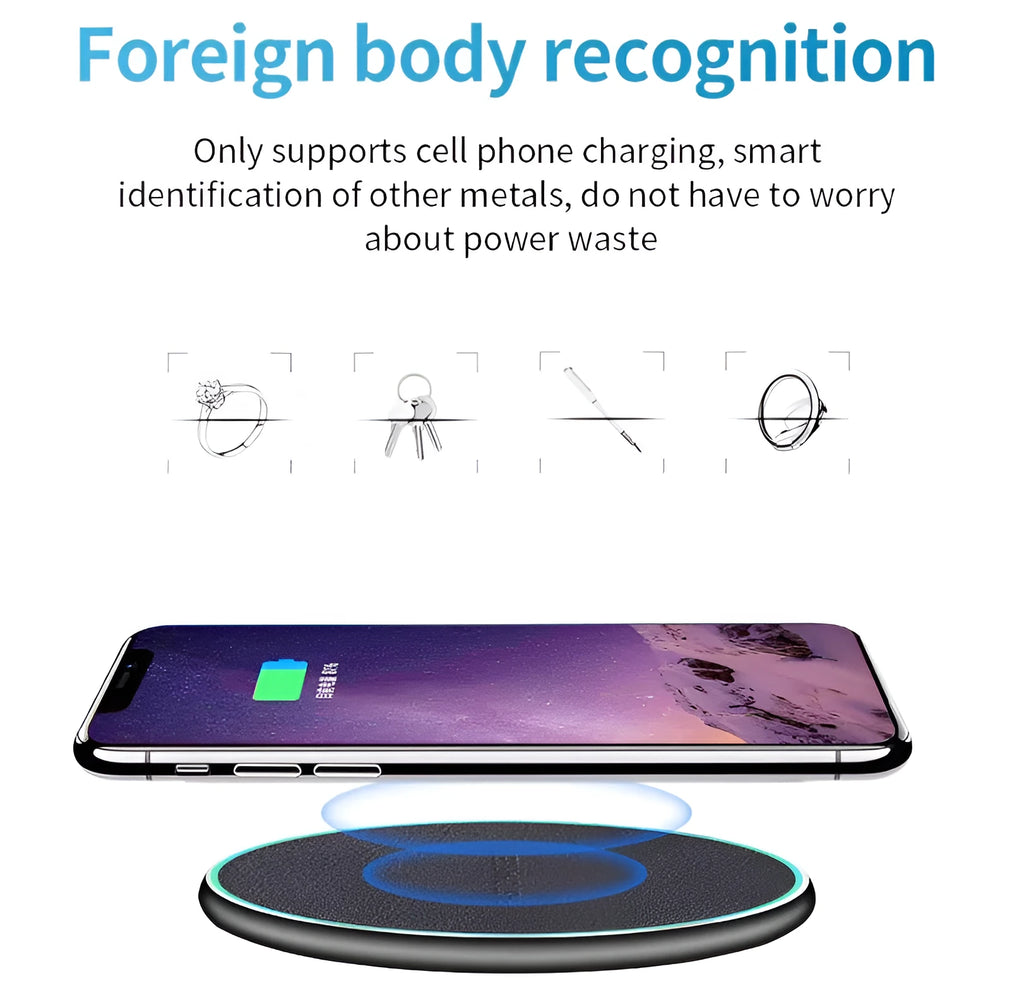 Black circular Qi wireless charging pad for iPhone 11 on a desk.