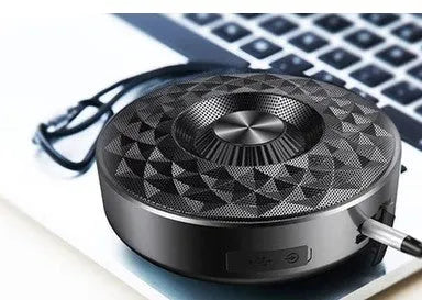 Compact black, orange, and silvery white Bluetooth wireless sound box speaker on a surface.